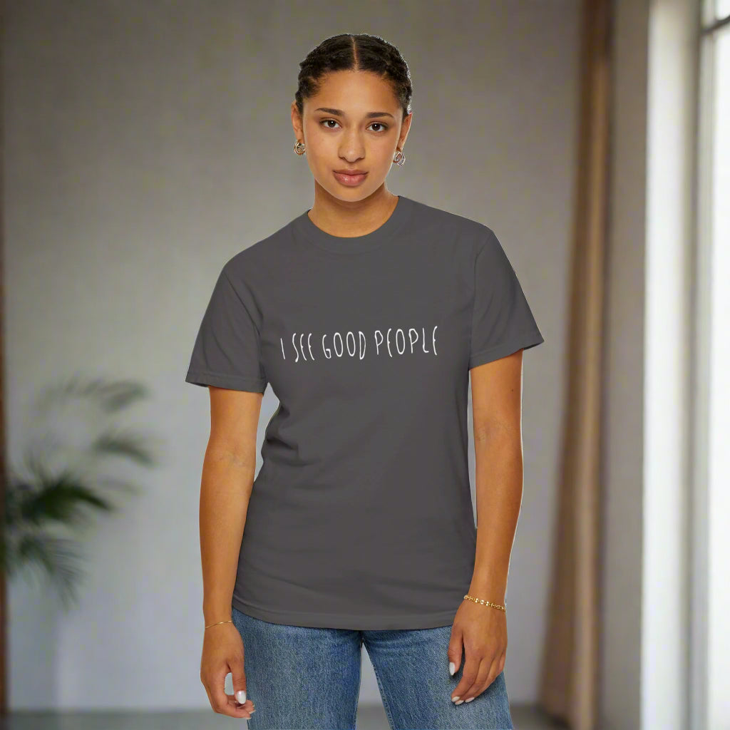 A front-facing view of a woman wearing a gray 'I See Good People' unisex t-shirt. The minimalist white text design on the garment-dyed fabric highlights the shirt's relaxed fit and positive message, perfect for spreading kindness and good vibes.