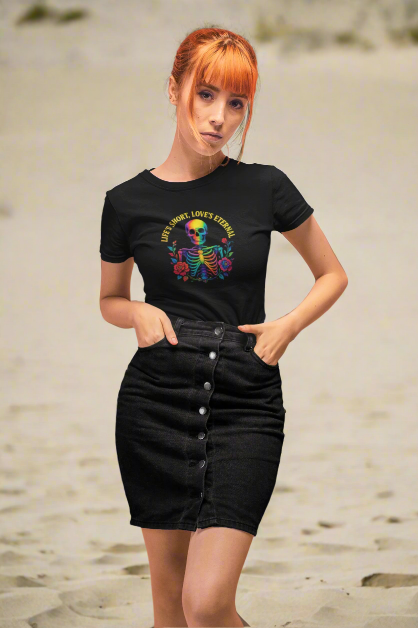Model wearing the 'Life's Short, Love's Eternal' rainbow skeleton tee from the ONE collection by Vibe with Kindness. Styled with a button-up black denim skirt, the look combines bold LGBTQ+ pride with sleek, modern fashion.