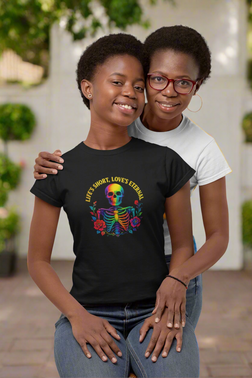 Mother and daughter duo wearing the 'Life's Short, Love's Eternal' rainbow skeleton tee from the ONE collection by Vibe with Kindness. The bold design features a colorful skeleton with roses, celebrating unity, love, and LGBTQ+ pride, while radiating positivity and connection.